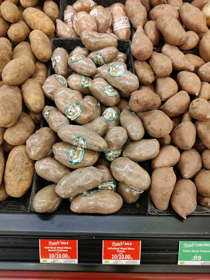 Plastic-wrapped potatoes on display in a store, highlighting wasteful unnecessary packaging.