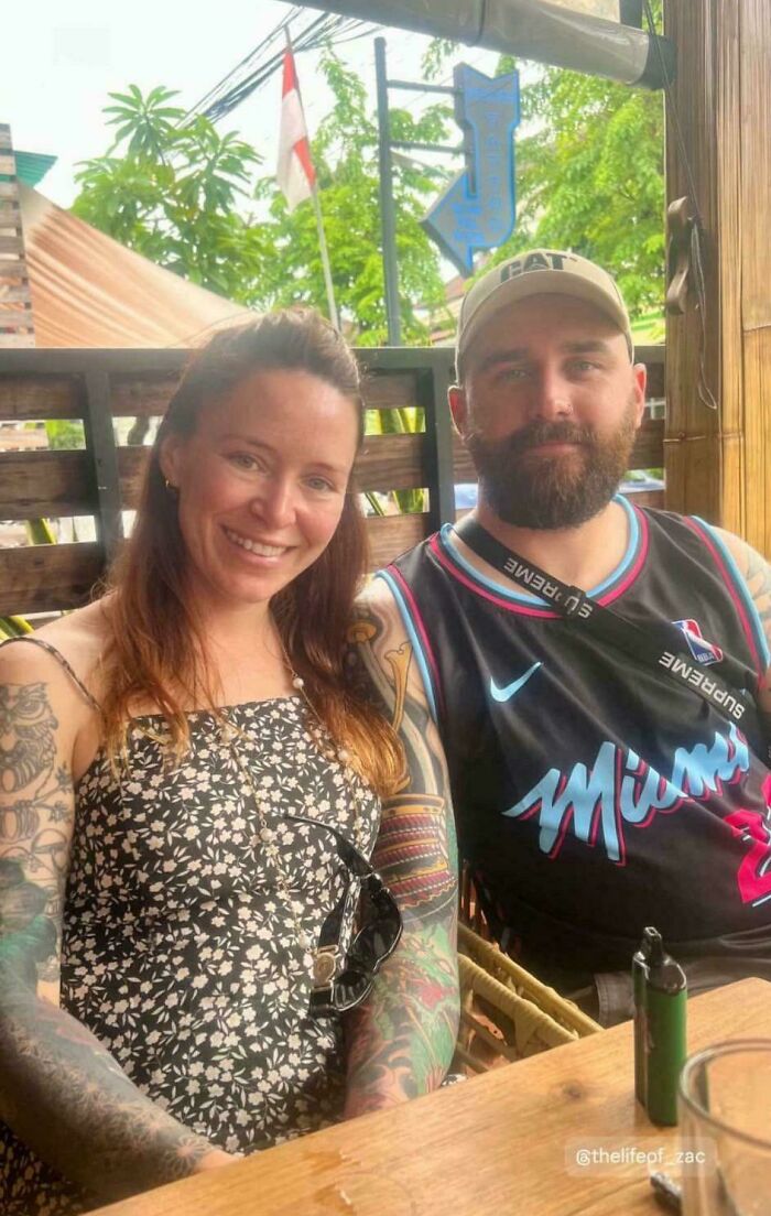 Couple sitting at a wooden table outdoors, showcasing confusing perspectives.