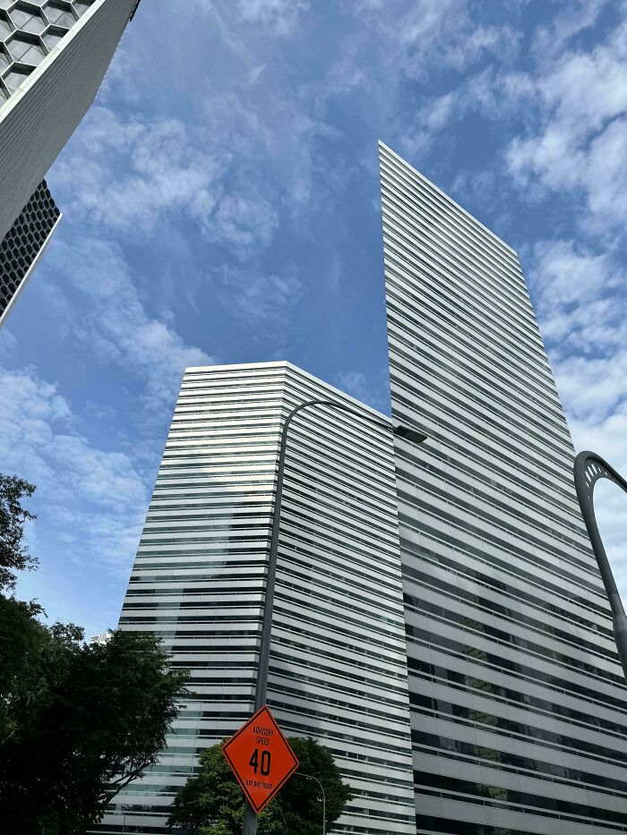 Confusing perspective of buildings with angled architecture and a sky backdrop.