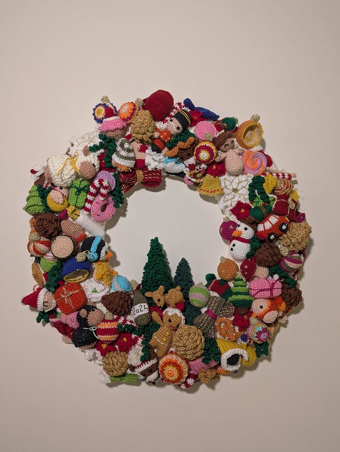 Crocheted wreath adorned with colorful miniatures, showcasing incredible crafting techniques in various shapes and designs.