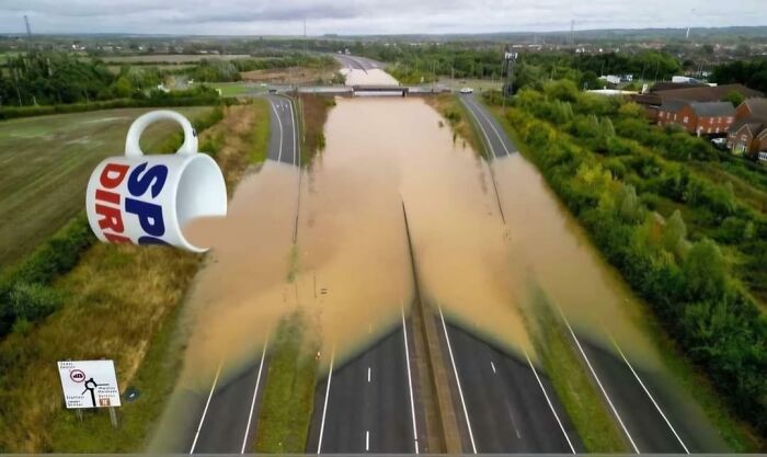 Flooded UK highway with a giant cup illusion, showcasing delightfully British humor.