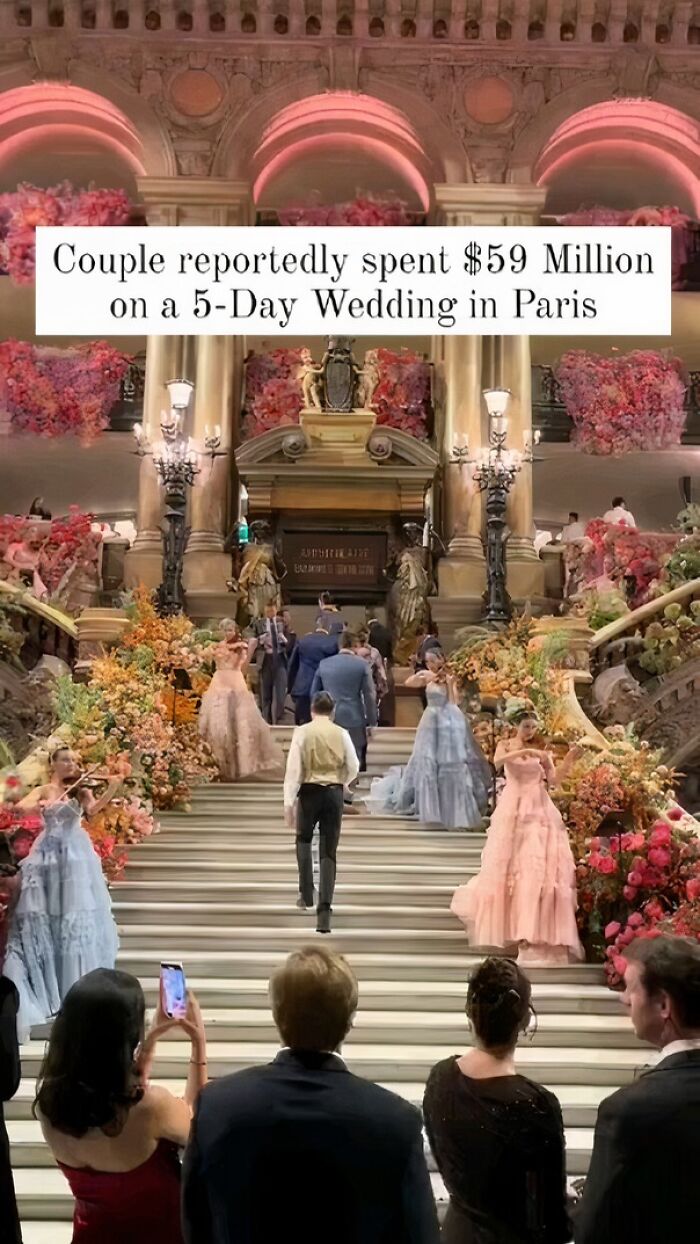 Luxurious wedding event with elegantly dressed guests on grand staircase, showcasing humans of capitalism pictures.