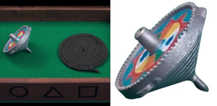 Toy top and coiled rope in a box with squid games symbols on green felt.