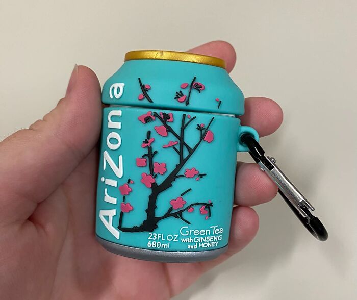 Novelty product featuring an Arizona Green Tea can design with flowers, held in a hand, adorned with a keychain clip.