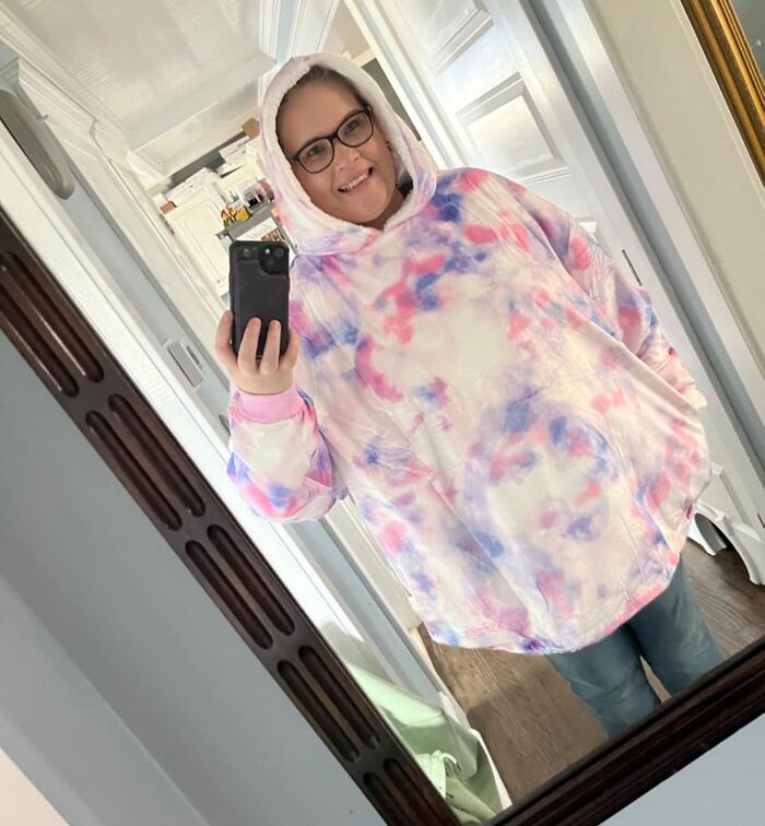 Person in colorful hoodie taking a selfie in mirror; related to biggest discounts on Amazon winter deals.