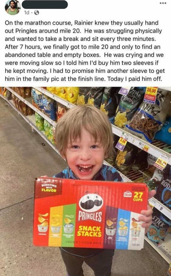 Child holding Pringles Snack Stacks box, smiling in a grocery store.