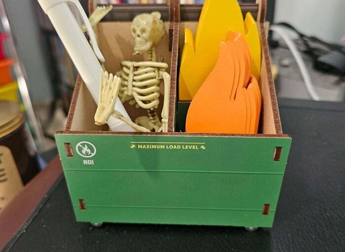 A desk caddy with skeleton and fire designs, showcasing a borderline genius product for office organization.