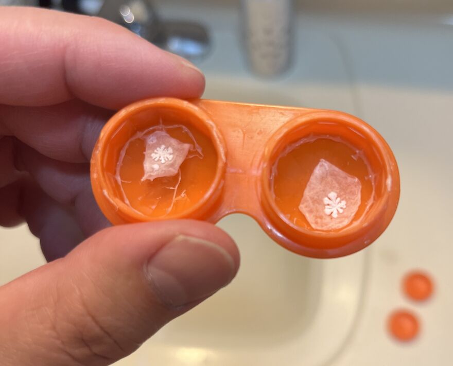 Orange contact lens case with shapes resembling snowflakes inside, illustrating things looking like other things.