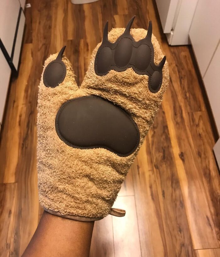 Bear paw oven mitt in a kitchen setting, one of the weirdest kitchen items that works surprisingly well.