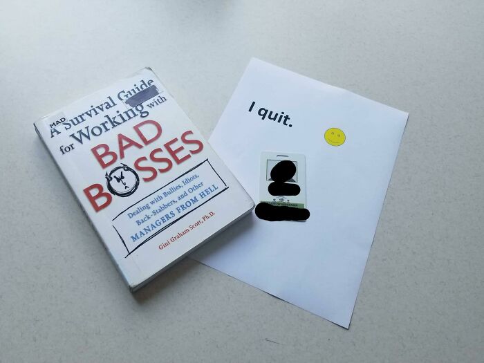 Book on bad bosses next to a resignation note, symbolizing people quitting jobs.