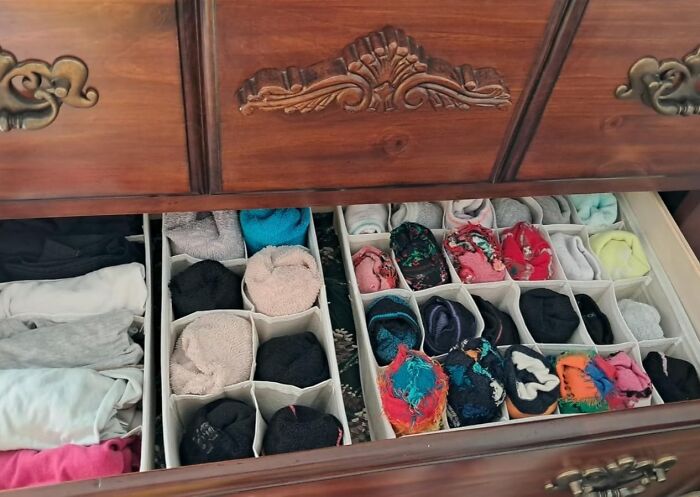 Organized drawer with neatly folded clothes and socks using Less-Mess-2025 dividers for optimal storage.