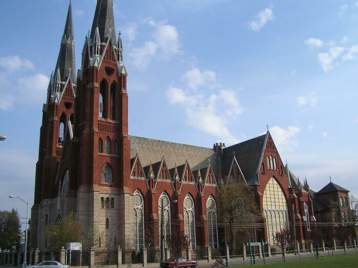 Gothic-style church with tall spires against a blue sky, part of fascinating church photos collection.