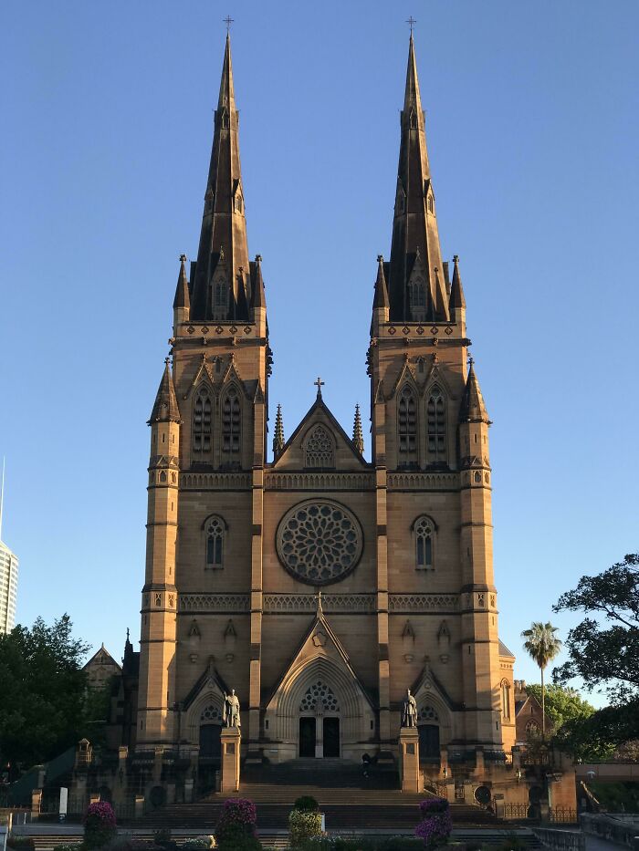 A stunning church with twin spires against a clear sky, showcasing intricate architectural details.