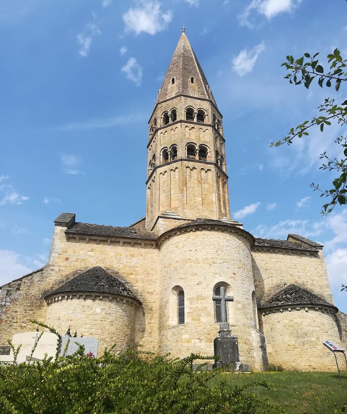 A captivating historical church with a tall spire against a bright blue sky.