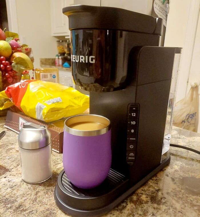 Keurig coffee maker with a purple mug, perfect cozy product for doing nothing inside.