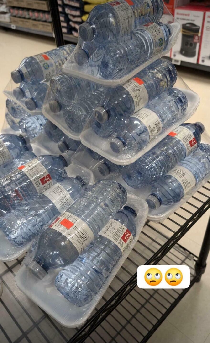 Bottled water in wasteful packaging on store shelf, highlighting unnecessary plastic use.