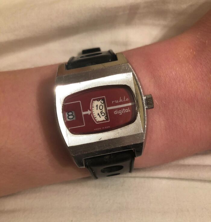 Vintage 80s digital wristwatch with a red face and classic design on a person's wrist.