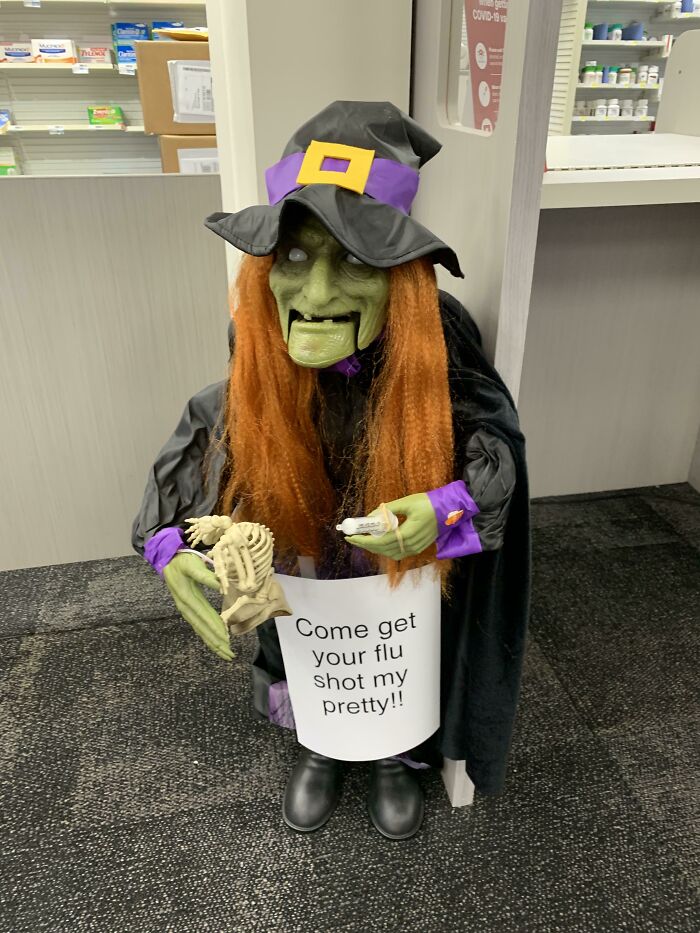 Witch decoration in local pharmacy promoting flu shots with humorous sign amidst infuriating local pharmacies theme.