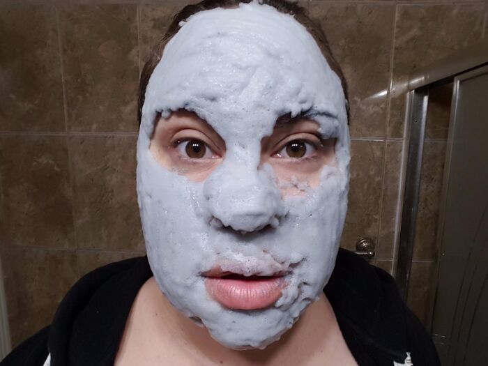 A person enjoying a facial mask as an irresistible treasure for self-care after a busy day.