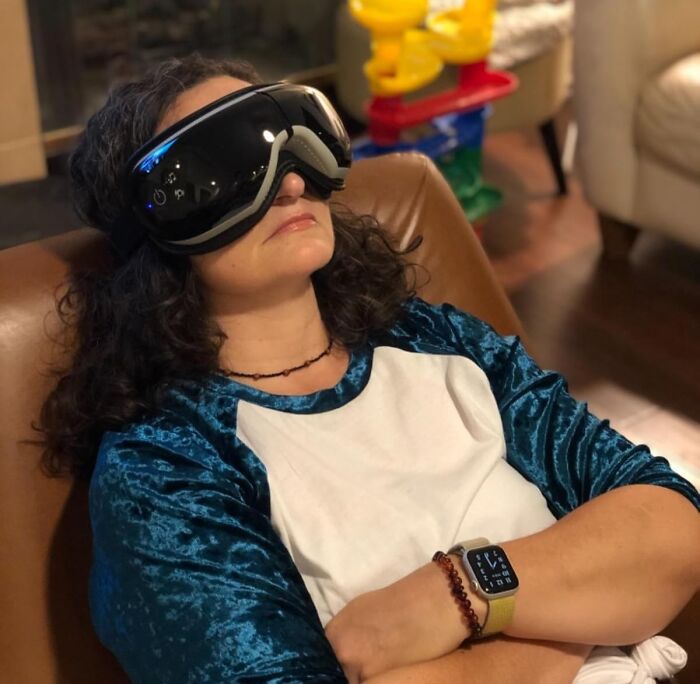 Woman relaxing with VR headset, enjoying an irresistible treasure after a busy day.