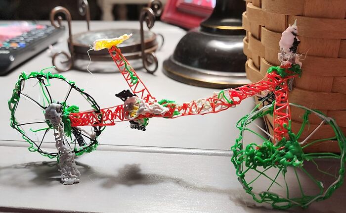 Colorful 3D-printed toy bike made with a DIY pen, illustrating innovative gadgets for 2025.