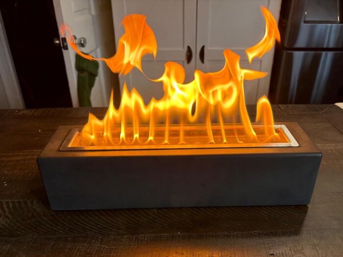 Modern tabletop fire display, a leading innovation in best gadgets for 2025, enhancing ambiance with vibrant flames.