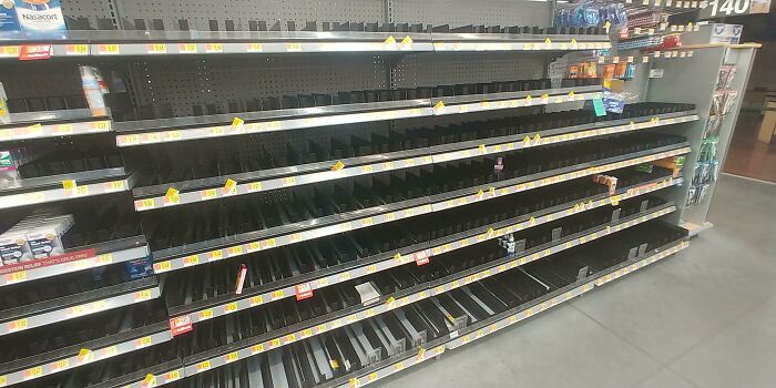 Empty shelves at a local pharmacy indicating a shortage of supplies.