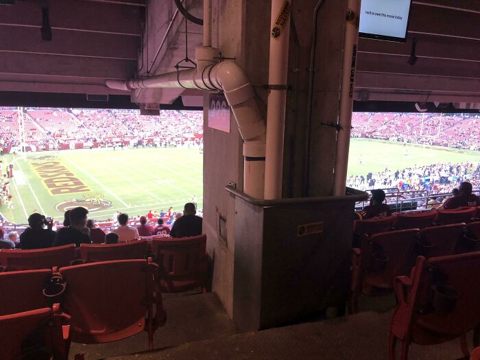 Stadium seating obstructed by a large structural column, showcasing unfortunate interior design.