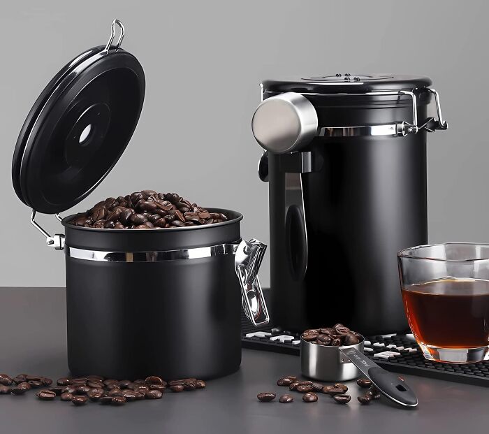 Containers filled with coffee beans, a measuring scoop, and a glass of brewed coffee promoting a responsible lifestyle.