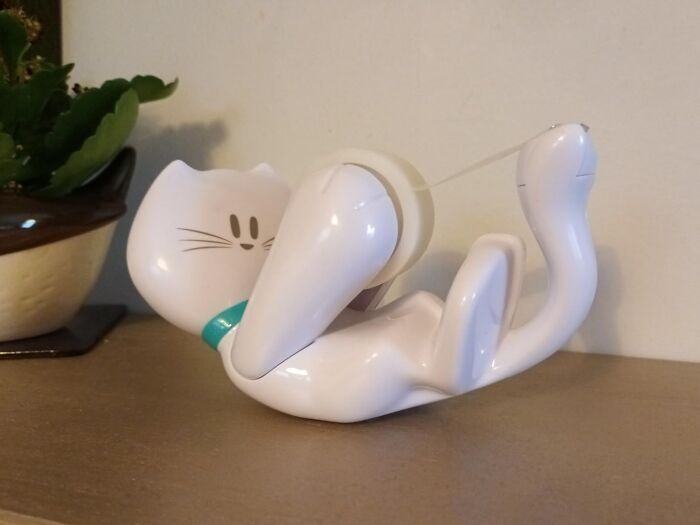 Cat-shaped tape dispenser, a playful office supply adding fun to workspaces.