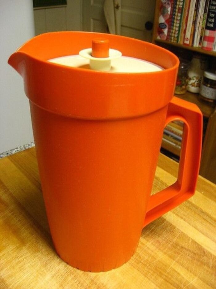 Orange plastic pitcher from the 80s, exemplifying nostalgic kitchenware from that era.