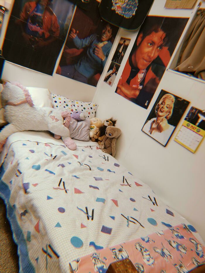 80s nostalgia bedroom with celebrity posters, stuffed animals, and patterned bedding.