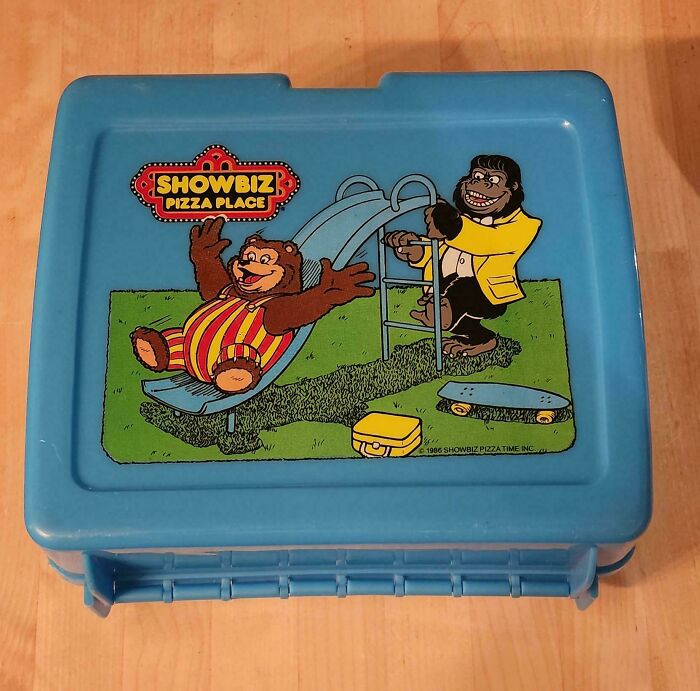 Vintage 80s Showbiz Pizza Place lunchbox featuring cartoon gorillas on a slide.