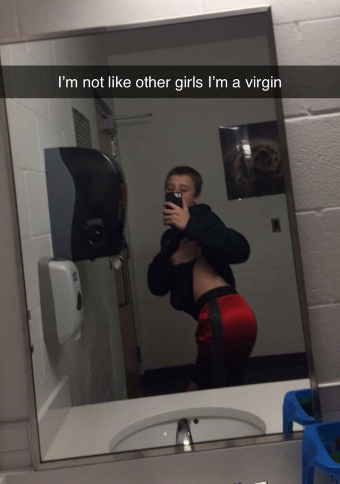 Mirror selfie with humorous caption in a bathroom, highlighting a funny camera roll find.