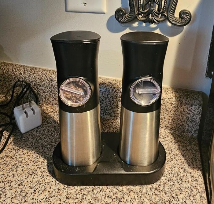 Electric salt and pepper grinders on a kitchen counter for better cooking.