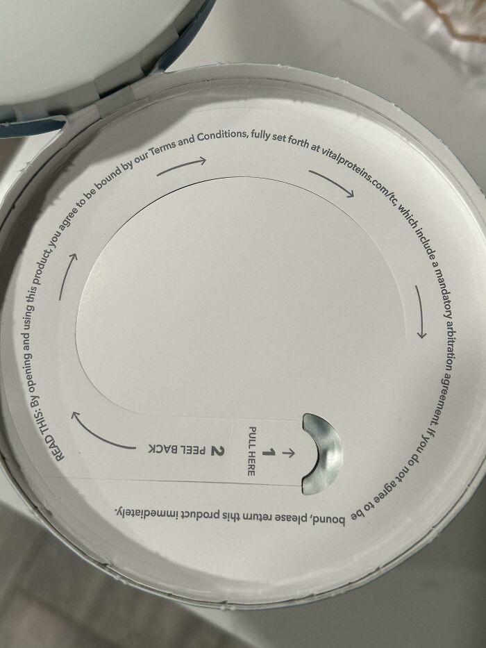 Close-up of a product lid with peel instructions, showcasing cool design surprises.