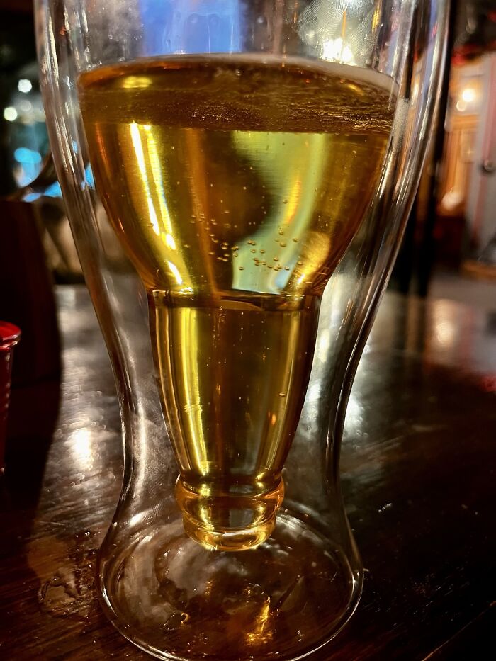 Unique beer glass with an inverted bottle shape, showcasing a cool product with surprises.