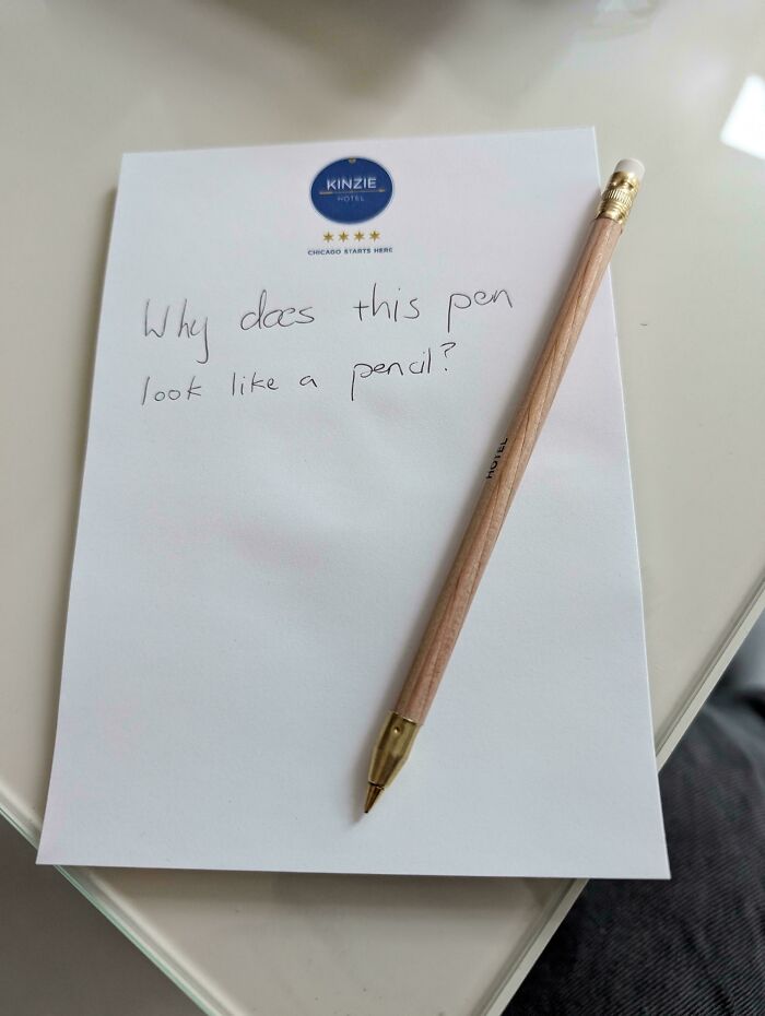 Pen designed to resemble a pencil on a notepad with handwritten message, reflecting cool products with surprises concept.