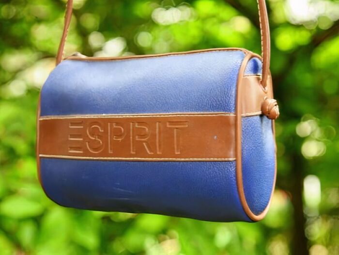 Blue and brown Esprit bag hanging, iconic for Gen X nostalgia.