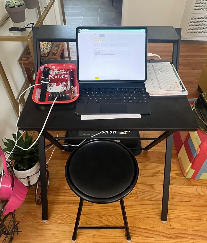 A compact desk setup with a laptop, showcasing smart furniture solutions for small living spaces.