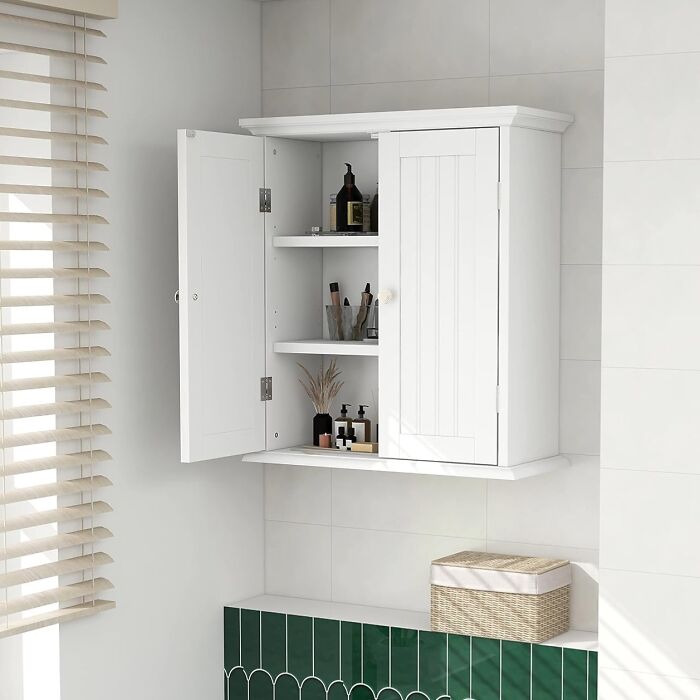 White wall-mounted cabinet with open shelves, showcasing smart storage solutions for small living spaces.