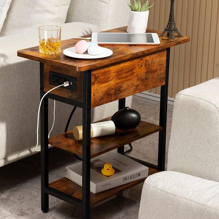 Compact side table with shelves and built-in charger maximizing small space efficiency.