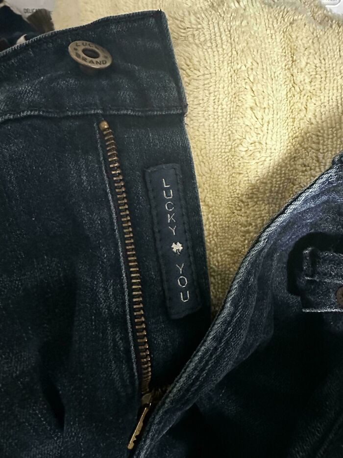 Denim zipper with "Lucky You" message, showcasing a cool product surprise detail.