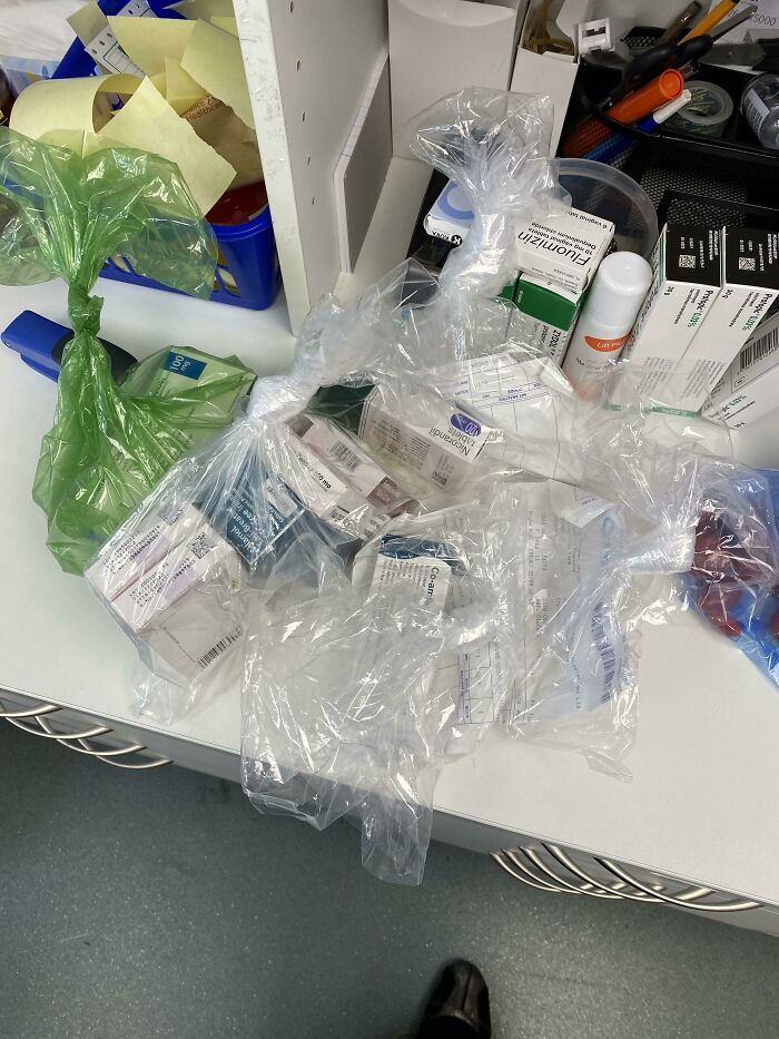 Plastic bags with medicine on a cluttered pharmacy counter, illustrating issues with local pharmacies.