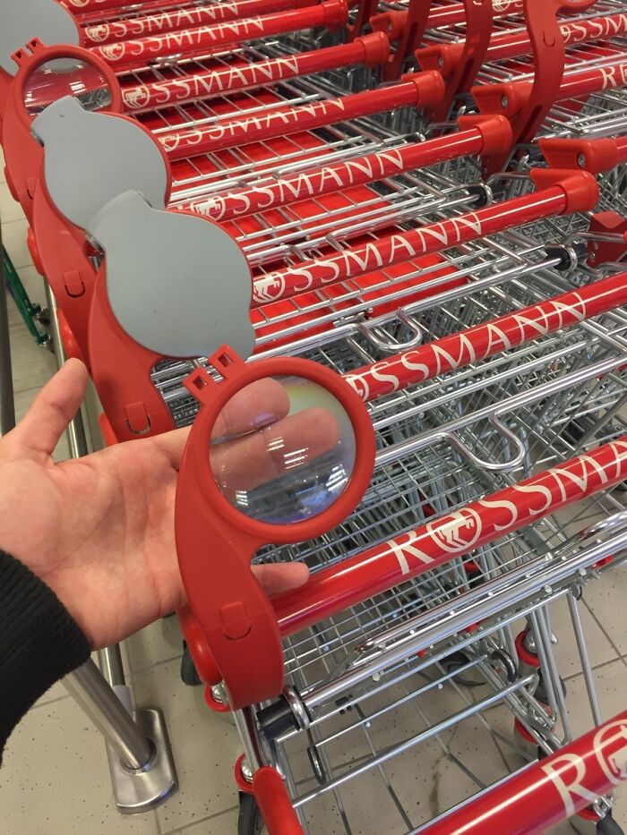 Shopping cart with an attached magnifying glass handle, showcasing cool product surprises.