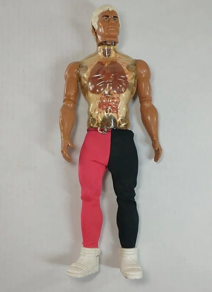 Gen X toy figure with transparent chest and red-black pants, wearing white boots.