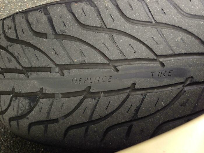 Worn tire with the word "REPLACE" revealed, showcasing surprises in cool products.