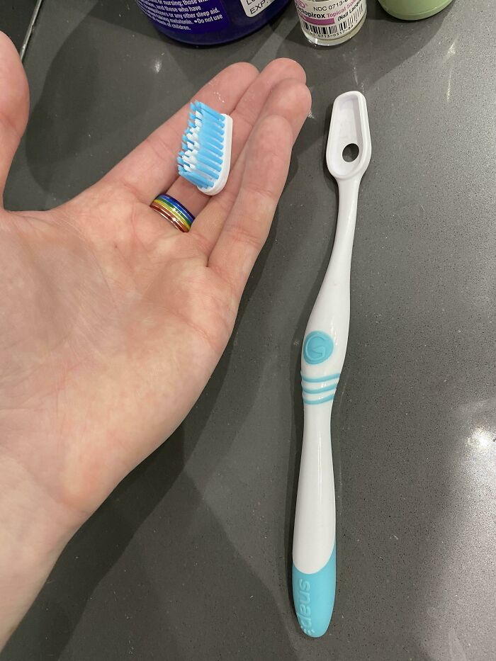 Removable toothbrush head beside its handle, showcasing a cool product with surprises.