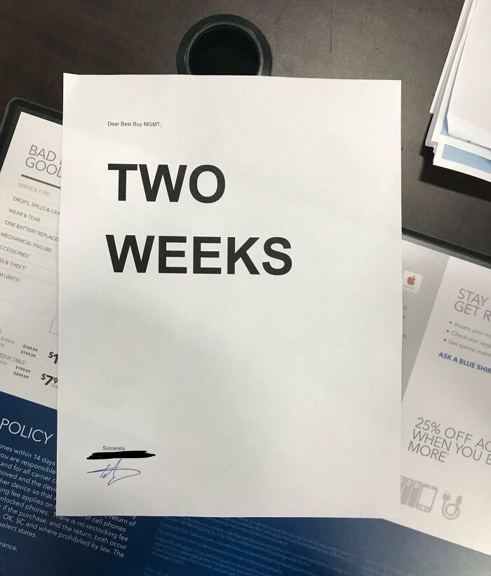 Resignation letter on a desk, highlighting "TWO WEEKS," representing people quitting jobs.