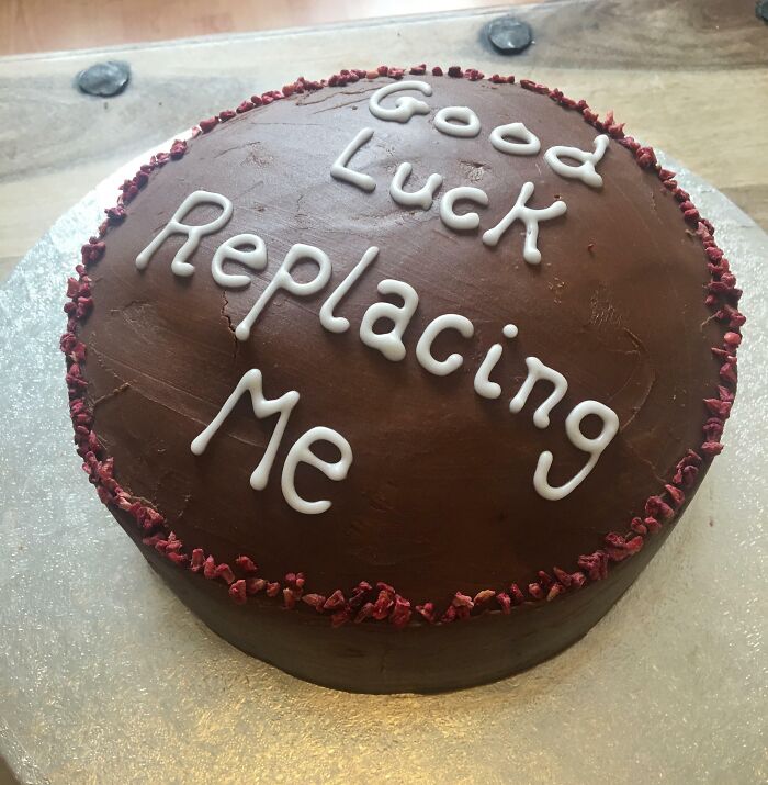 Chocolate cake with "Good Luck Replacing Me" written on it, symbolizing people quitting jobs.